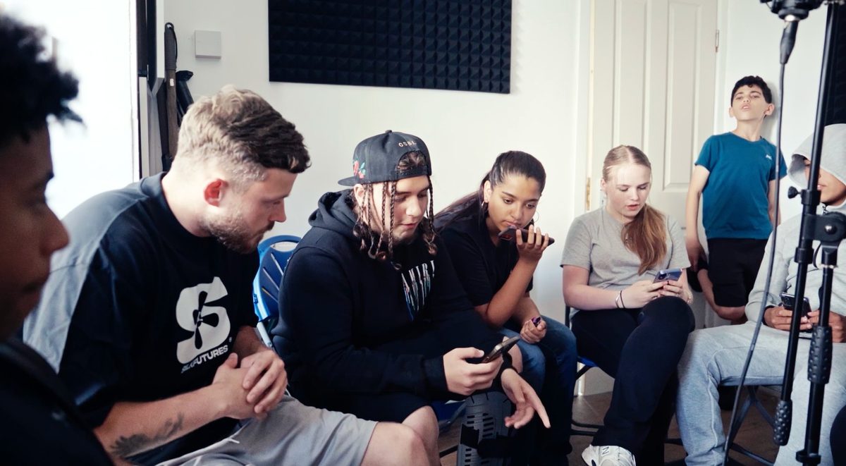 Benny leading a group session at Grangetown — young people gathered in the studio