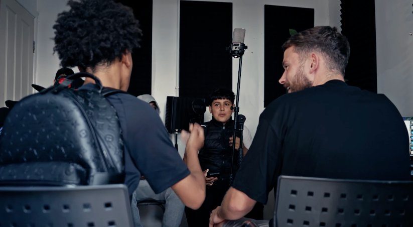 Mentor and young people in conversation in the studio