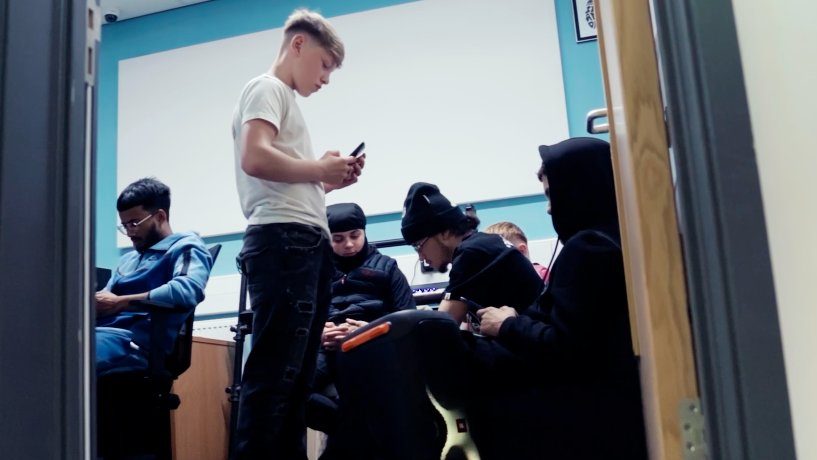 Young people writing lyrics in the session room